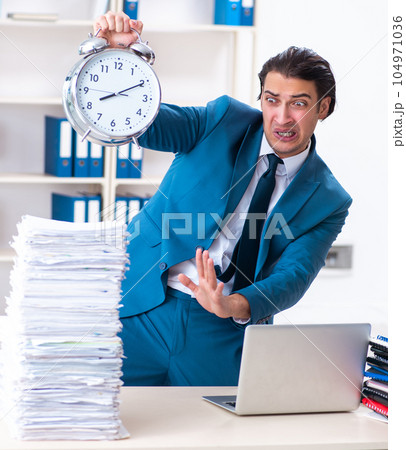 Young male employee unhappy with excessive work Young male employee unhappy with excessive work 104971036