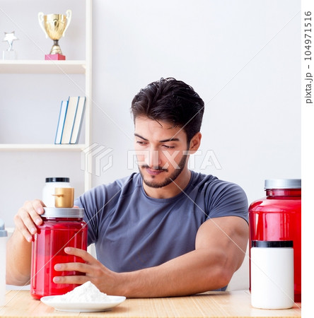 Athlete tasting new protein supplements for better muscles 104971516