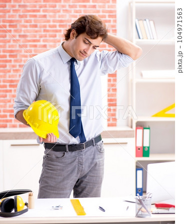 Construction supervisor working on blueprints Construction supervisor working on blueprints 104971563