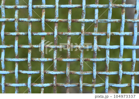 Iron painted mesh. Blue metal mesh close-up. iron fence. 104973337