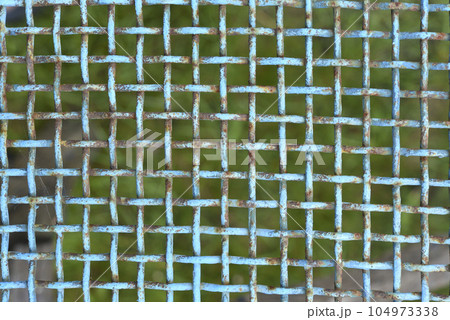 Iron painted mesh. Blue metal mesh close-up. iron fence. 104973338