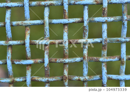 Iron painted mesh. Blue metal mesh close-up. iron fence. 104973339