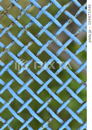 Iron painted mesh. Blue metal mesh close-up. iron fence. 104973340
