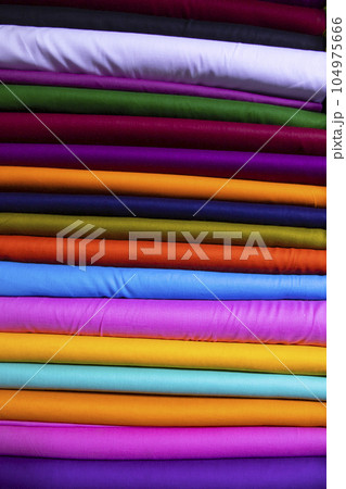 Artistic variety of shade tone colors Textile Fabrics stacked on retail Shop Shelves for sale     Artistic variety of shade tone colors Textile Fabrics stacked on retail Shop Shelves for sale     104975666