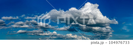 Fluffy clouds on a clear sunny day Fluffy clouds on a clear sunny day 104976733