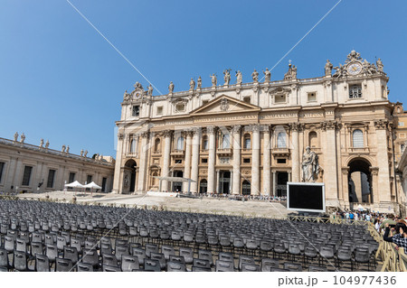 Saint Peter's Square is a large plaza located directly in front of St. Peter's Basilica in Vatican City. Chairs are prepared for mass and general audience. Saint Peter's Square is a large plaza located directly in front of St. Peter's Basilica in Vatican City. Chairs are prepared for mass and general audience. 104977436