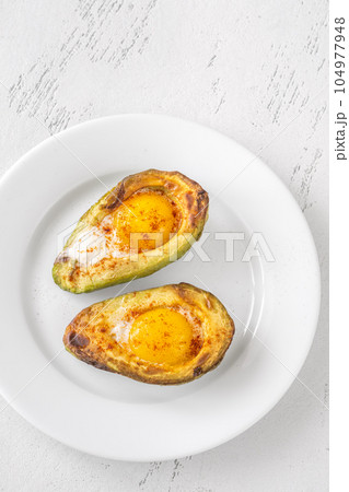 Baked eggs in avocado Baked eggs in avocado 104977948