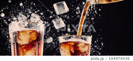 Pouring of Cola and Ice. Cola soda and ice splashing fizzing or floating up to top of surface. Close up of ice in cola water. Texture of carbonate drink with bubbles in glass. Cold drink background 104978436