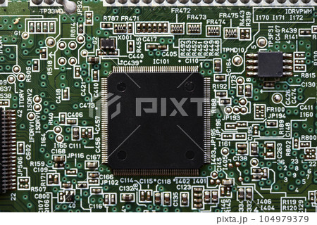Blue board with radio elements. A chip with a processor and transistors. Diodes and resistors. Microchip. Blue board with radio elements. A chip with a processor and transistors. Diodes and resistors. Microchip. 104979379