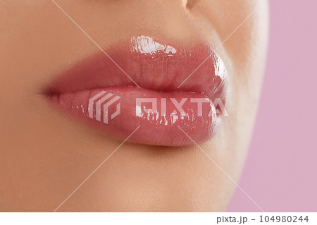 Young woman with beautiful full lips on pink background, closeup Young woman with beautiful full lips on pink background, closeup 104980244