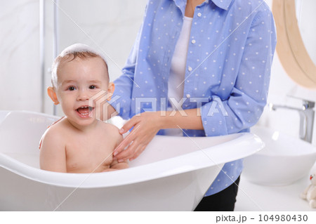 Mother with her little baby in bathroom Mother with her little baby in bathroom 104980430