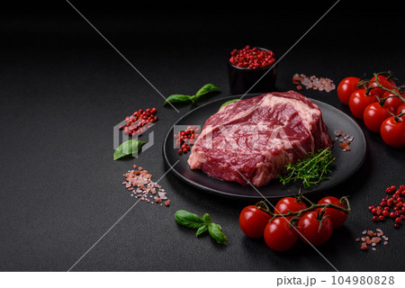 Fresh, raw beef steak with salt, spices and herbs Fresh, raw beef steak with salt, spices and herbs 104980828
