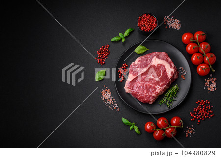 Fresh, raw beef steak with salt, spices and herbs Fresh, raw beef steak with salt, spices and herbs 104980829