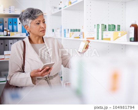 Pharmacy, shelf and a woman with medicine and a phone for information or research on pills. Shopping, mature and a person in a store for medication, reading box with mobile for analysis or knowledge Pharmacy, shelf and a woman with medicine and a phone for information or research on pills. Shopping, mature and a person in a store for medication, reading box with mobile for analysis or knowledge 104981794