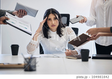 When can I leave. Shot of a young businesswoman looking stressed out in a demanding work environment. When can I leave. Shot of a young businesswoman looking stressed out in a demanding work environment. 104981842