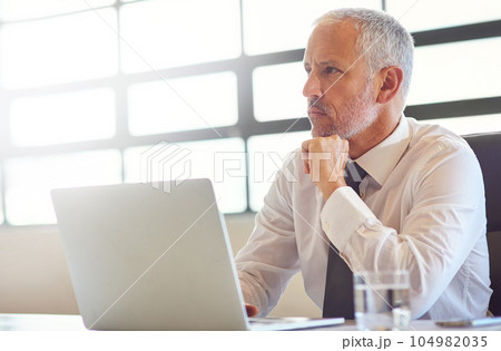 Laptop, thinking and research with a business man in the office, working online to finish a project at his desk. Computer, idea and email with a mature male manager at work for company opportunity Laptop, thinking and research with a business man in the office, working online to finish a project at his desk. Computer, idea and email with a mature male manager at work for company opportunity 104982035