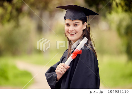 Im taking this with me to the top. Portrait of a young woman holding her diploma on graduation day. Im taking this with me to the top. Portrait of a young woman holding her diploma on graduation day. 104982110