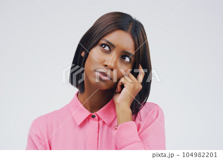 Confused, thinking and woman in studio with decision on mockup, space and white background. Choice, contemplation and indian female person with doubt, emoji and problem solving of ideas for questions 104982201