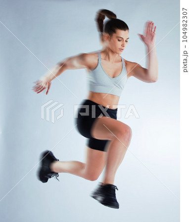 Time to level up. Full length shot of an attractive young female athlete posing in studio against a grey background. Time to level up. Full length shot of an attractive young female athlete posing in studio against a grey background. 104982307