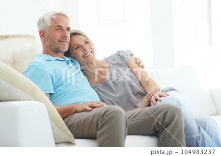 Senior couple, retirement and thinking on a couch at home with love, care and support from life insurance. Commitment of a man and woman in a healthy marriage with security on living room couch Senior couple, retirement and thinking on a couch at home with love, care and support from life insurance. Commitment of a man and woman in a healthy marriage with security on living room couch 104983237