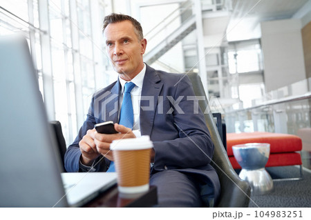 Thinking, corporate or business man with phone in office for communication, social networking or content blog review. Coffee, laptop or manager with smartphone for social media, search or mobile app 104983251