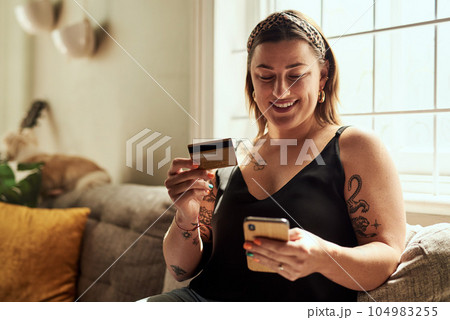 Phone, credit card and woman on sofa online shopping, e commerce and fintech payment, loan or happy finance. Person on couch typing banking information on mobile app for home transaction and finance 104983255