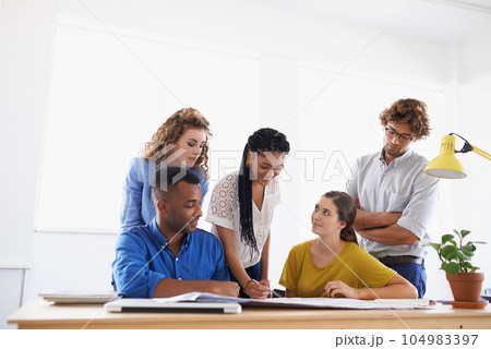 Diversity, business people and writing in team project, planning or strategy together at office. Group of diverse employees working on paperwork, documents or teamwork for brainstorming at workplace 104983397