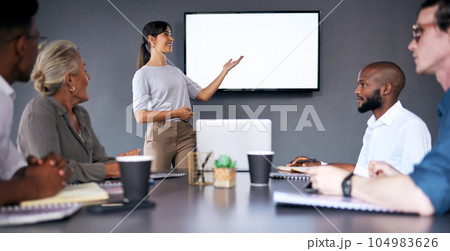 Everyone is moving forward together. Shot of an young businesswoman giving a presentation during a meeting in the boardroom. Everyone is moving forward together. Shot of an young businesswoman giving a presentation during a meeting in the boardroom. 104983626