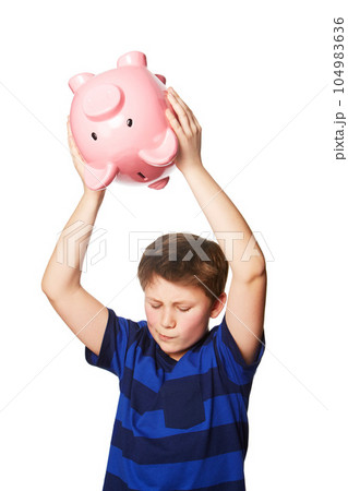 Piggy bank, smash and young boy in studio for finance, savings and decision against white background. Money box, breaking and preteen male person with investment, cash and future financial freedom 104983636