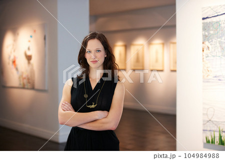 Pride, arms crossed and portrait of a woman at an art gallery for an exhibition. Creative, culture and a museum manager with management of paintings, collection and curator of pictures at a studio 104984988