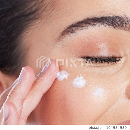 Skincare, closeup and woman with cream on face, anti ageing and collagen treatment for skin glow. Dermatology, cosmetics and morning beauty routine, facial lotion on model with moisturiser product. Skincare, closeup and woman with cream on face, anti ageing and collagen treatment for skin glow. Dermatology, cosmetics and morning beauty routine, facial lotion on model with moisturiser product. 104984989