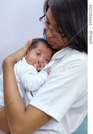 Medicine, cleft lip and a pediatrician with a baby in the hospital for healthcare, insurance or treatment. Medical, children and a doctor woman holding a newborn infant with a disability in a clinic 104985288