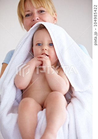 Baby, towel and portrait with care for mother with comfort or love in a closeup or family home. Mom, hug and holding an infant for bath with cleaning or affection at house for hygiene with happy kid. Baby, towel and portrait with care for mother with comfort or love in a closeup or family home. Mom, hug and holding an infant for bath with cleaning or affection at house for hygiene with happy kid. 104985422