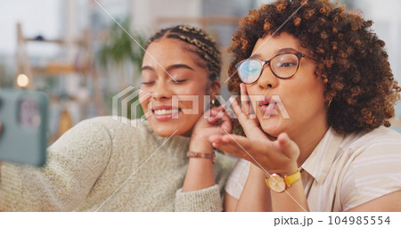 Happy women smiling for photo, memory or facial expression for social media post. Woman, friends and smile for selfie, vlog or profile picture together blowing kiss by living room table at home. 104985554
