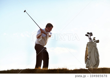 Stroke, golf and man with driver on course outdoor for training, workout or fitness on blue sky mockup space. Golfing, club and person swinging for game, competition or exercise, sports and wellness. Stroke, golf and man with driver on course outdoor for training, workout or fitness on blue sky mockup space. Golfing, club and person swinging for game, competition or exercise, sports and wellness. 104985678