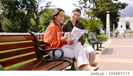 Women, friends and laughing at park on bench, bonding and talking together. Girls, outdoor and happiness of people in conversation, comic discussion or comedy and enjoying quality time for friendship 104985715