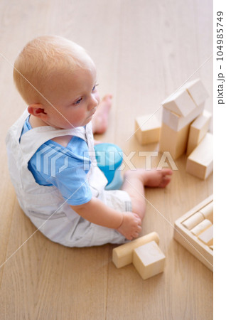 Little baby boy, toys and wooden blocks on floor for playtime, learning or childhood development at home. Cute, adorable or growing infant of newborn, child or toddler playing on the ground in house Little baby boy, toys and wooden blocks on floor for playtime, learning or childhood development at home. Cute, adorable or growing infant of newborn, child or toddler playing on the ground in house 104985749