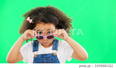 Portrait, green screen and a girl looking over her glasses in studio to ask a question with attitude. Kids, fashion and eyewear with an adorable little female child on chromakey mockup for style 104986182