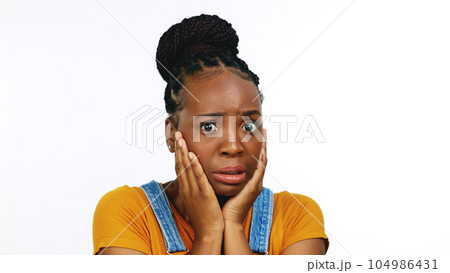 Scared, shock and confused with face of black woman for announcement, gossip and news. Fear, secret and surprise with portrait of girl and omg expression for frightened, notification or wow in studio 104986431