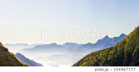 Wide panorama of morning mountain hills. Carpathian mountains at sunrise. 104987777