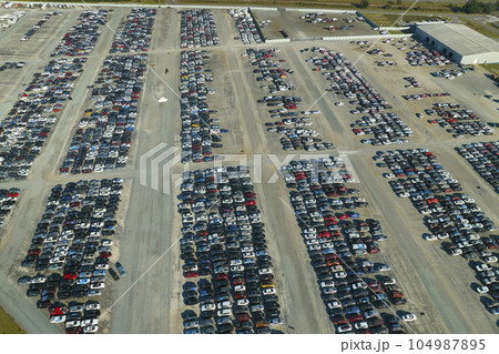 View from above of big parking lot with parked used cars after accident ready for sale. Auction reseller company selling secondhand broken vehicles for repair View from above of big parking lot with parked used cars after accident ready for sale. Auction reseller company selling secondhand broken vehicles for repair 104987895