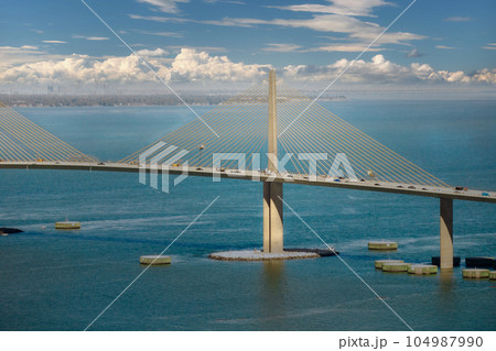 Sunshine Skyway Bridge over Tampa Bay in Florida with moving traffic. Concept of transportation infrastructure 104987990