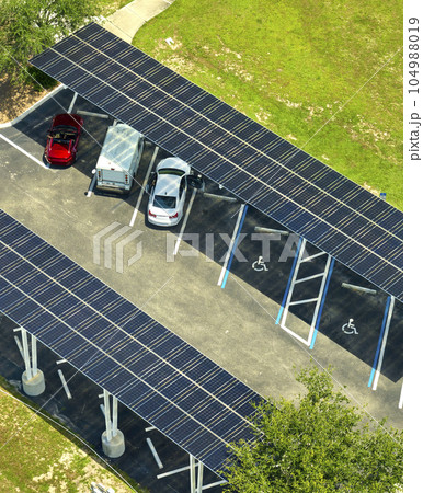 Solar panels installed over parking lot for parked cars for effective generation of clean energy 104988019