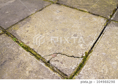 Old and broken cracked concrete floor tiles Old and broken cracked concrete floor tiles 104988298