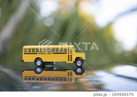 Model of classical american yellow school bus for transporting of kids to and from school every day. Concept of education in the USA 104988370
