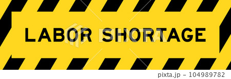 Yellow and black color with line striped label banner with word labor shortage 104989782