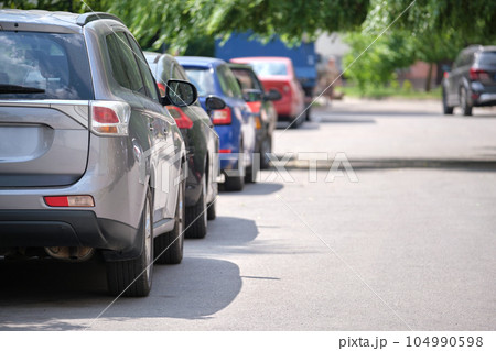 Cars parked in line on city street side. Urban traffic concept Cars parked in line on city street side. Urban traffic concept 104990598