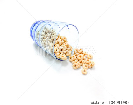 Isolated of cereal pour from the blue glass 104991908