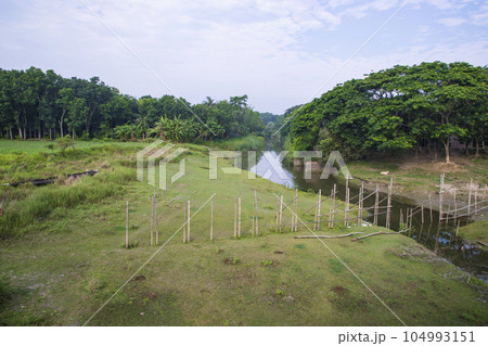 River water flows through the cannel with a greenery landscape view under the blue sky River water flows through the cannel with a greenery landscape view under the blue sky 104993151