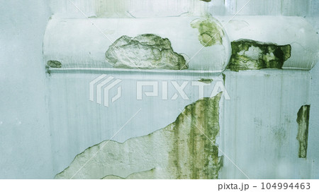 A wall with damp old paint. A wall with damp old paint. 104994463